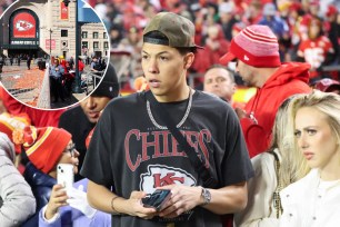 Jackson Mahomes help a child during the Chiefs Super Bowl parade.