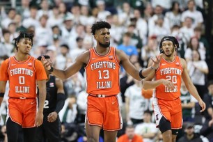 Quincy Guerrier of the Illinois Fighting Illini reacts to a call with teammates Terrence Shannon Jr. and Ty Rodgers.