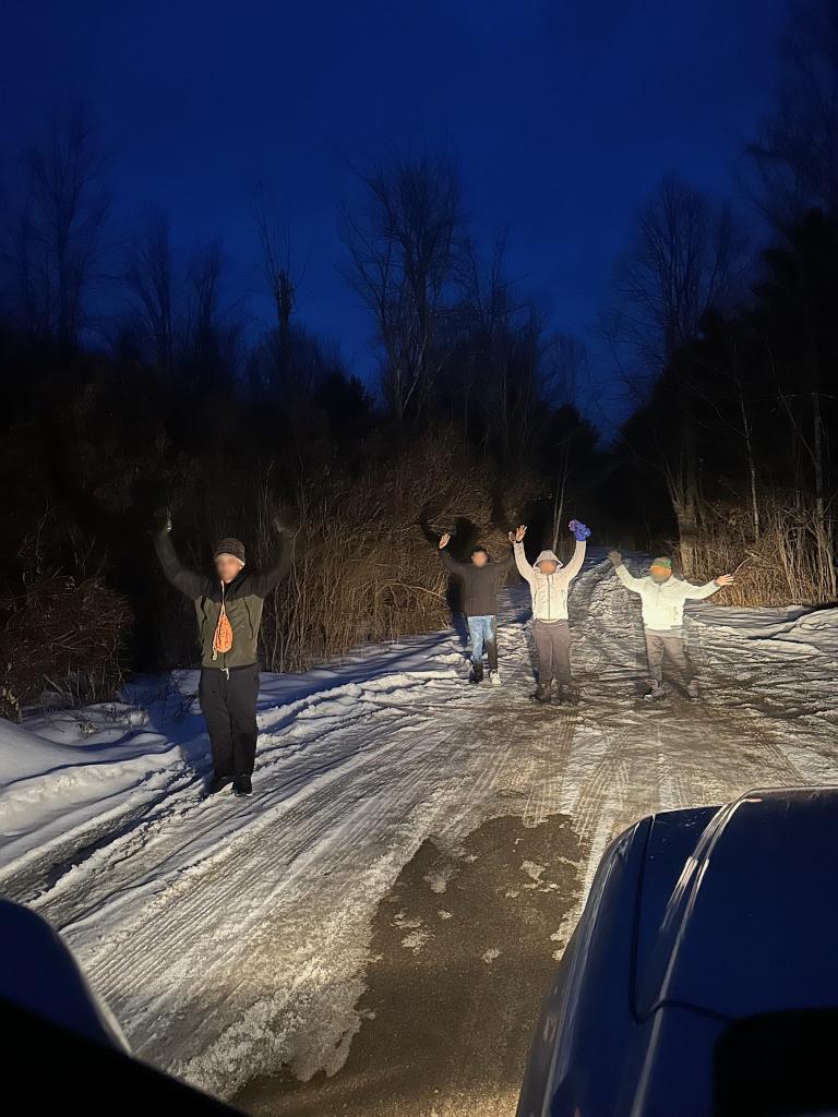 Migrants are seen crossing into the US from Canada.