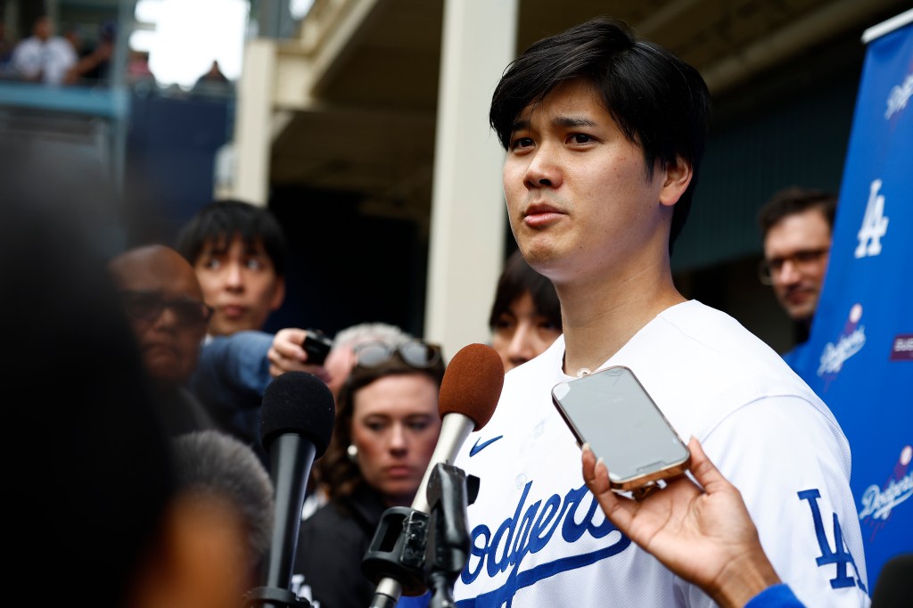 Shohei Ohtani #17 of the Los Angeles Dodgers speaks with the media during DodgerFest at Dodger Stadium.
