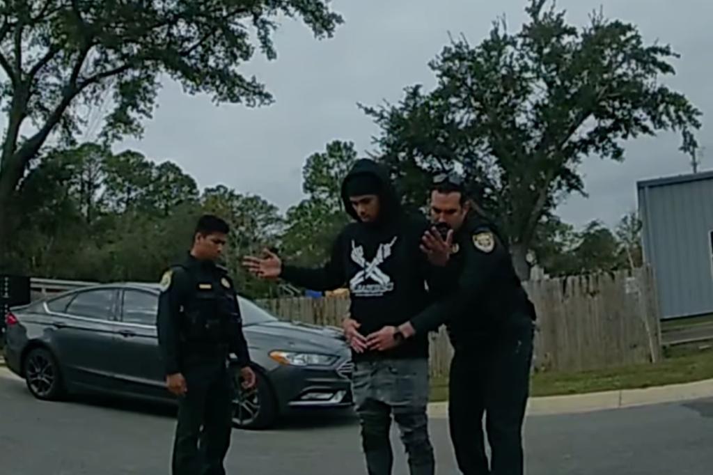 Cops pat down suspect outside the car