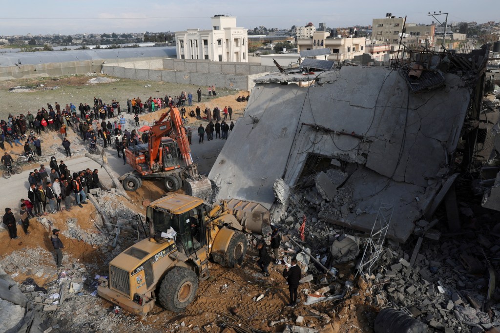 Palestinians inspect a house hit by an Israeli strike, in Rafah in the southern Gaza Strip February 16, 2024. 