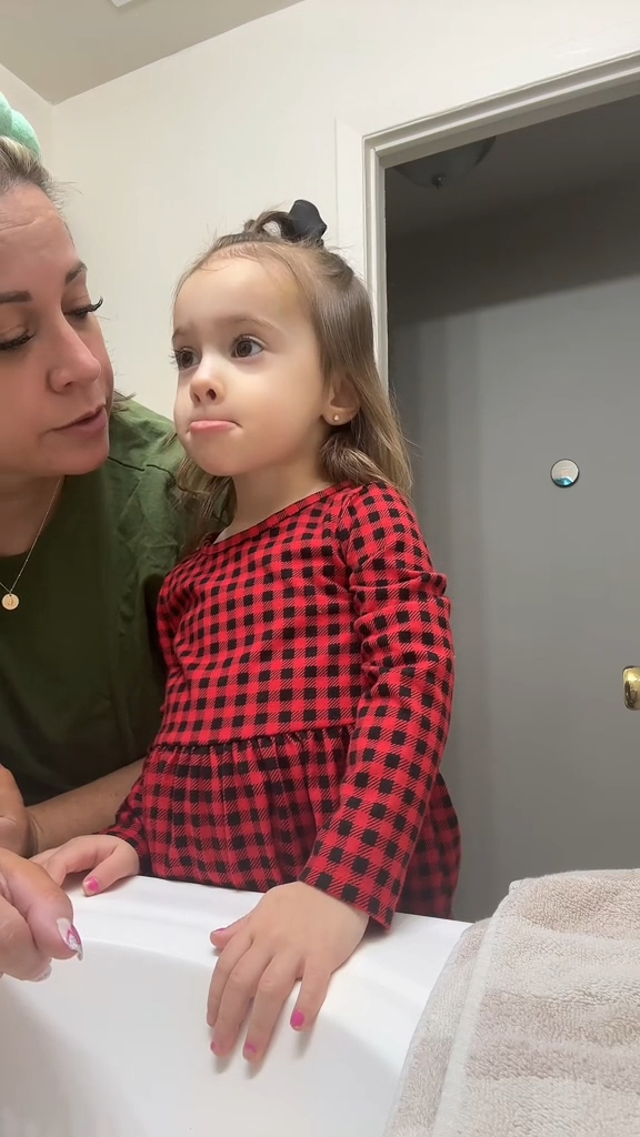 little girl in bathroom with her mom