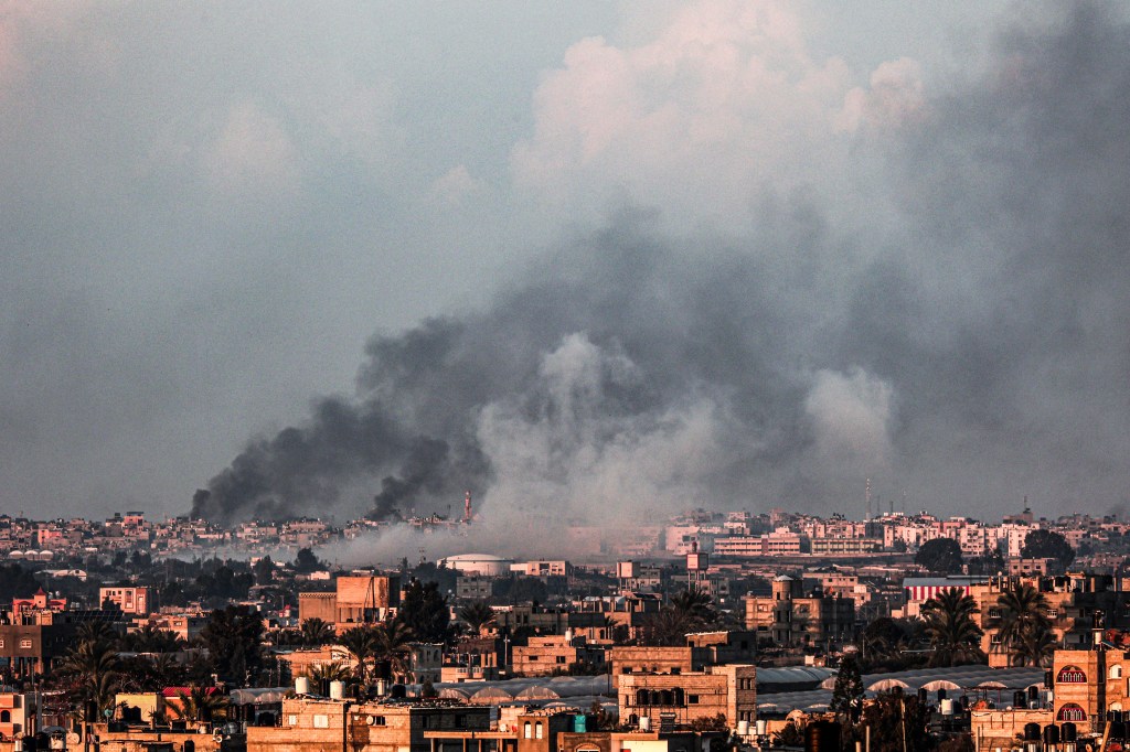A picture taken from Rafah shows smoke billowing over Khan Yunis in the southern Gaza Strip during Israeli bombardment on Feb. 18.
