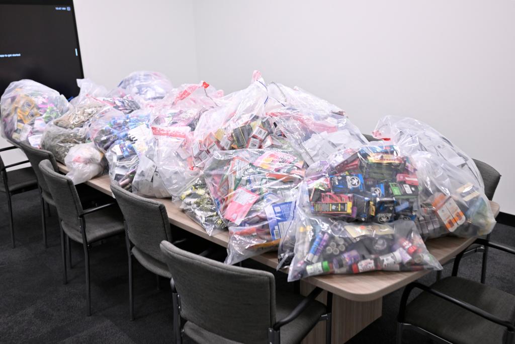 Plastic bags filled with products on a table, seized from illegal shops in East Village during NYS Gov. Hochul's Cannabis Enforcement Announcement.