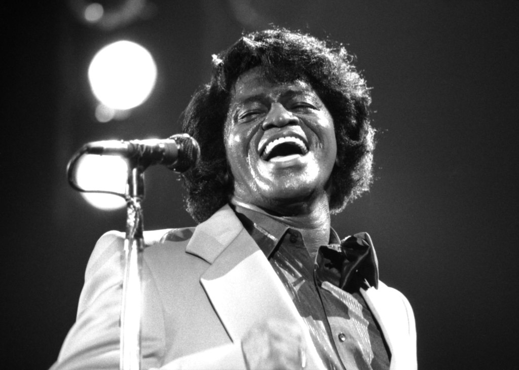 james brown singing at a microphone