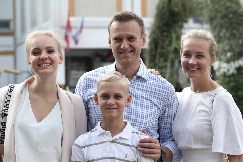 Russian opposition leader Alexei Navalny with his wife, son and daughter pose for a photo after voting during a city council election in Moscow.
