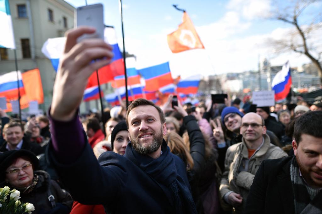 Russian opposition leader and anti-corruption blogger Alexei Navalny takes a selfie picture as he attends a memorial march marking the one-year anniversary of the assassination of Russian politician Boris Nemtsov in central Moscow,