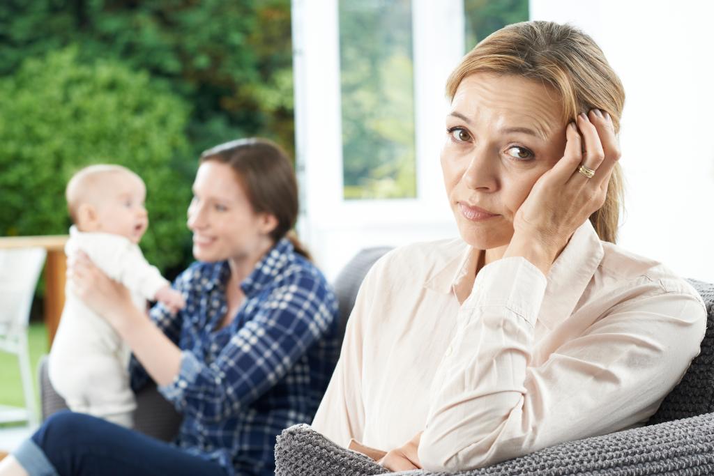 Sad Mature Woman Jealous Of Mother With Young Baby