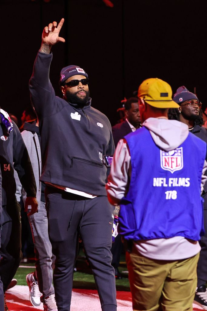Trent Williams raising his hand in a crowded event for Super Bowl 2024 Opening Night in Las Vegas.