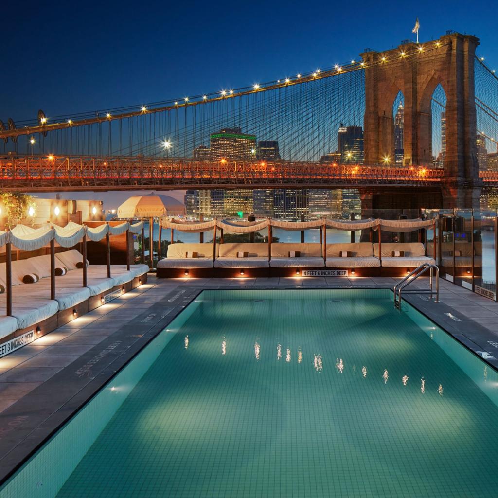 Soho House Dumbo - a pool with a bridge in the background.