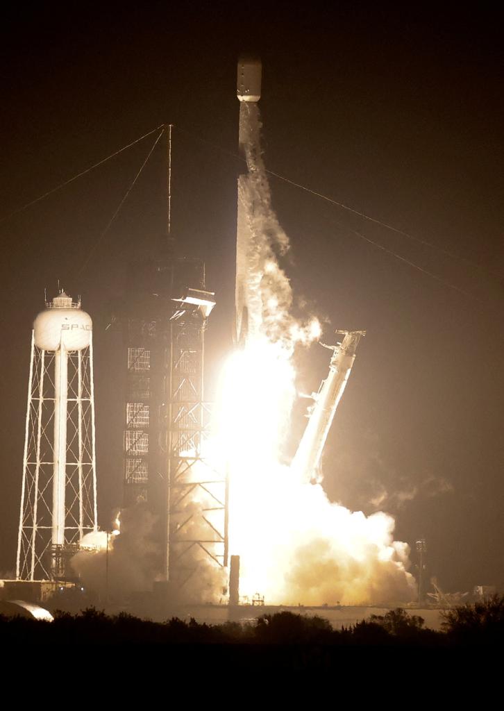 A SpaceX Falcon 9 rocket taking off at night from the Kennedy Space Center in Cape Canaveral carrying the Nova-C moon lander for the IM-1 mission.