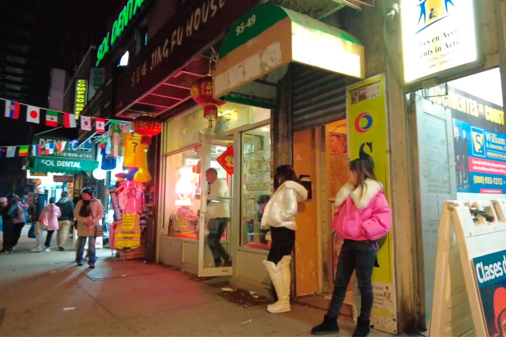 Alleged sex workers are seen along Roosevelt Avenue outside of storefronts in a YouTube video.