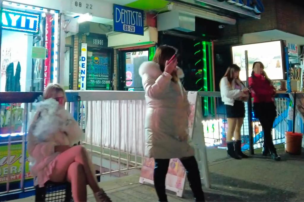 Alleged sex workers are seen along Roosevelt Avenue outside of storefronts in a YouTube video.