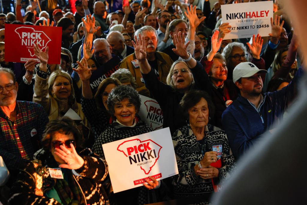 Supporters cheer as US Republican Presidential hopeful and former UN Ambassador Nikki Haley speaks during a campaign event in Clemson, SC.