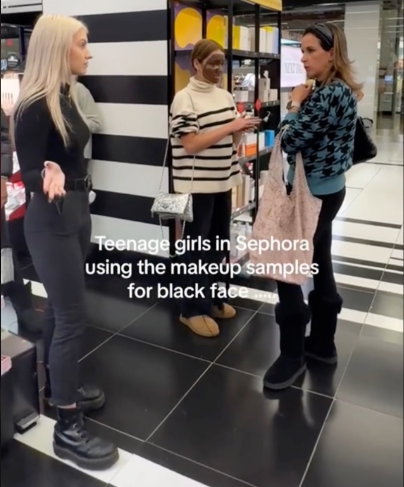 A store employee, left, confronted one of the girls' chaperones, who appeared to dismiss the criticisms. 