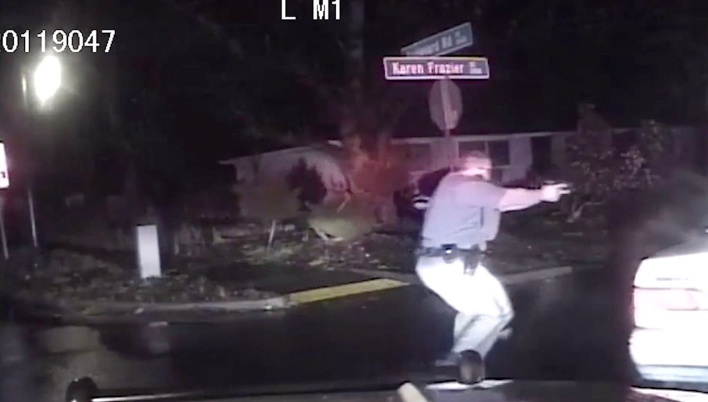 Dashcam footage shows Barnes approaching the vehicle with his gun drawn.