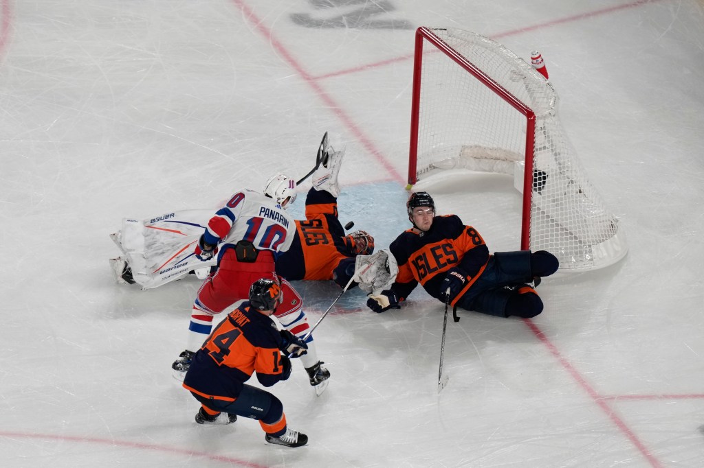 Noah Dobson slides into the net as Artemi Panarin scores the game-winning goal during the Islanders' loss to the Rangers on Feb. 18, 2024. 