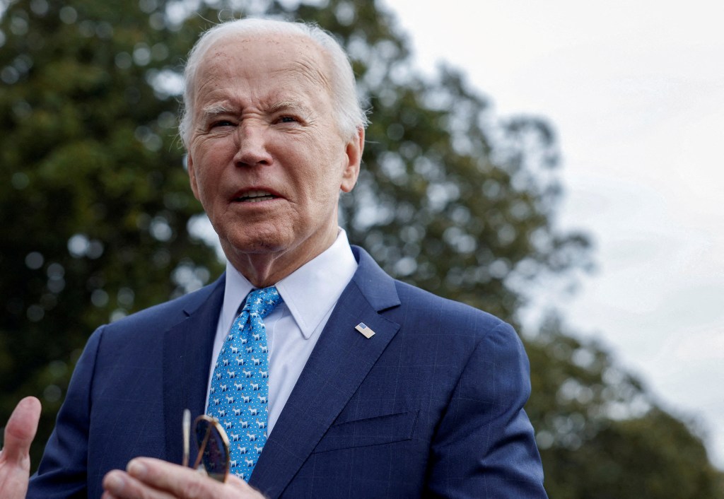 President Joe Biden looks on as he speaks to the media.