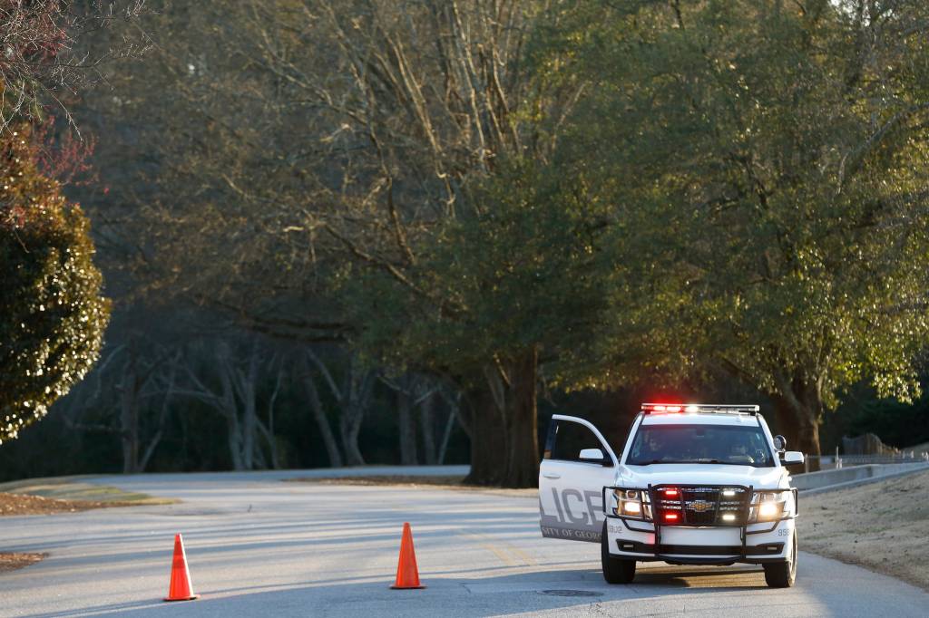 UGA police block the road to the back portion of the intramural fields to the trails around Lake Herrick one day after the murder of Athens nursing student Laken Riley in Athens, Ga., on Friday, Feb. 23. 2024.