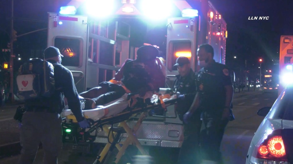 One of the victims of a Sunday morning shooting in Harlem being put in an ambulance.