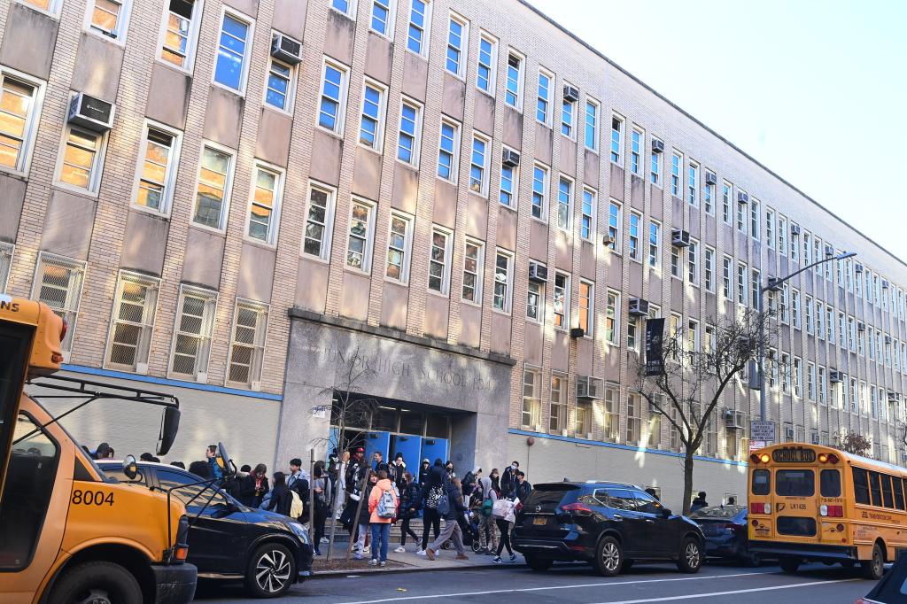 Group of students and parents stand outside Simon Baruch Middle School 104, where there is an outbreak of chickenpox, in New York.