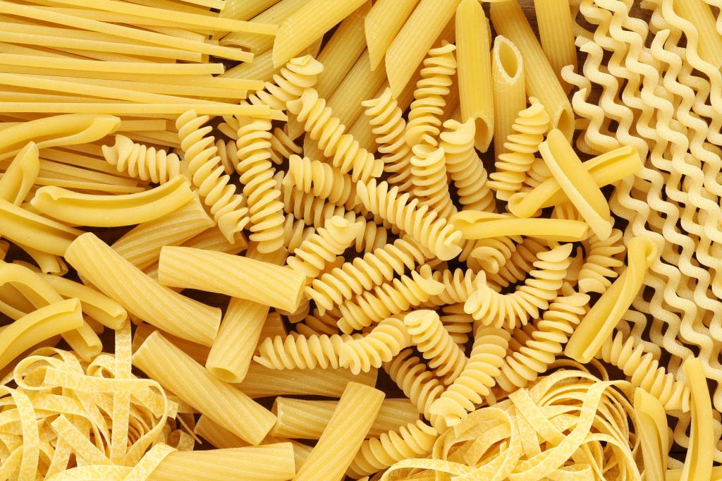 Variety of types and shapes of Italian pasta. Dry pasta background