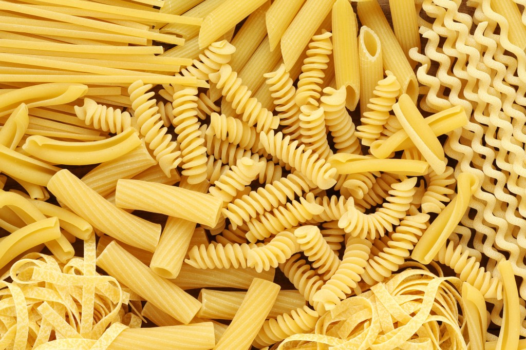 Variety of types and shapes of Italian pasta. Dry pasta background