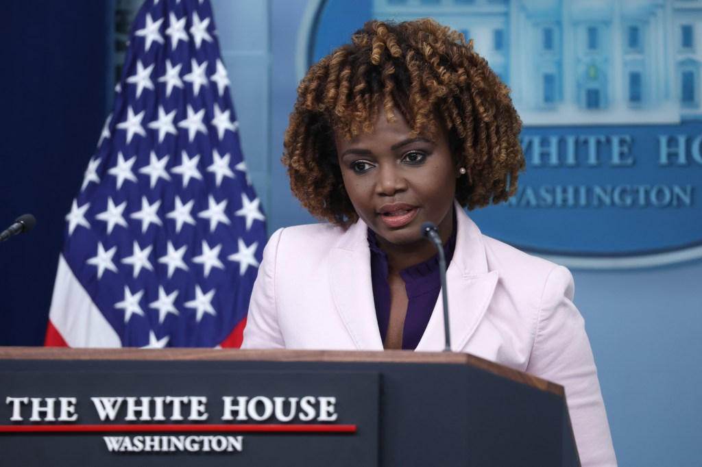 A woman speaking at a podium in the White House briefing room during a daily news briefing on February 6, 2024.