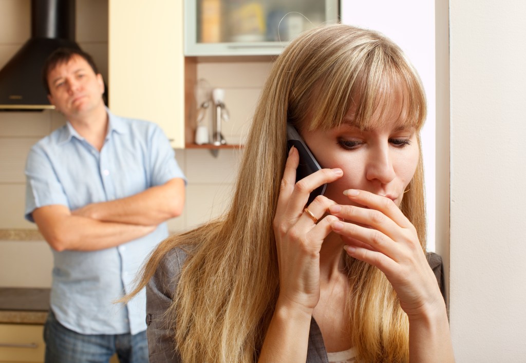 Wife on phone discussing privately.