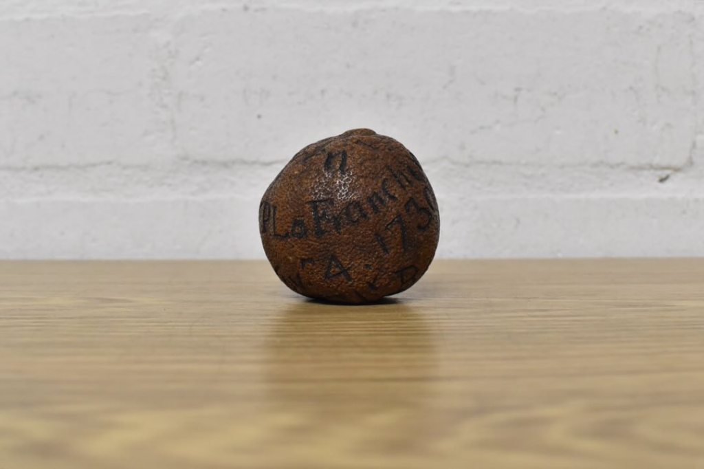 Brettells Auction House Facebook - a round object with writing on it.