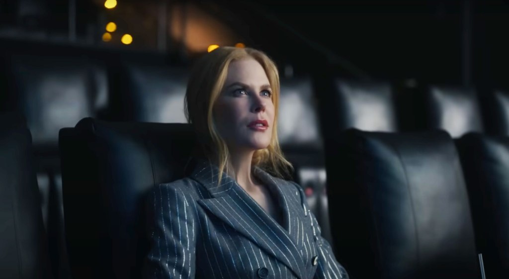 Nicole Kidman in the 2021 ad as she sits in an empty theater and is entranced by the movies on the screen.
