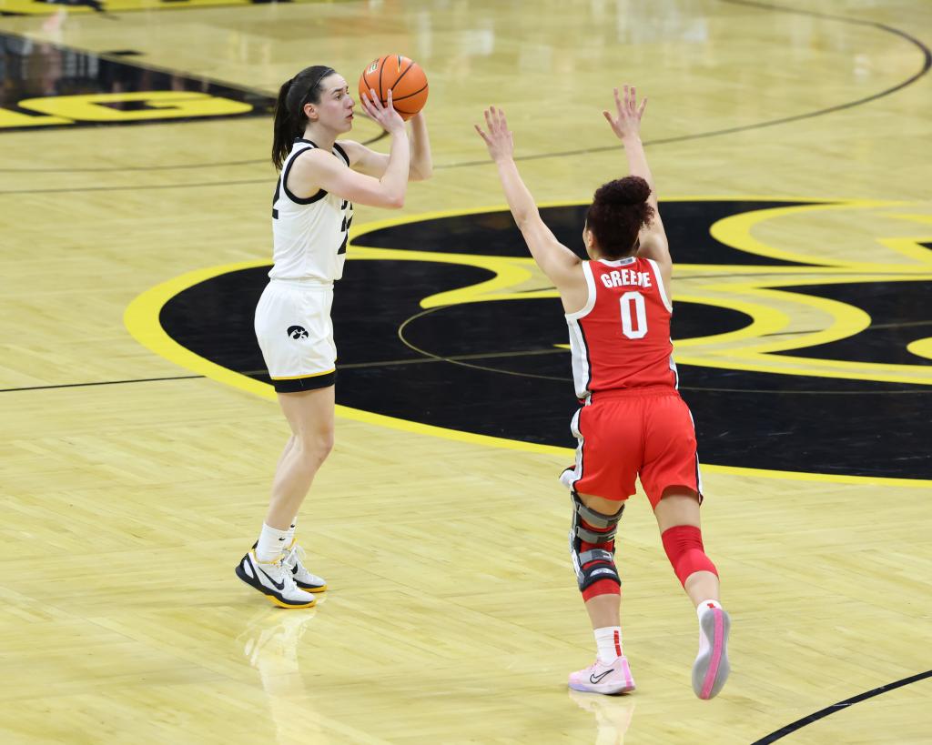 Buckeyes guard Madison Greene (0) attempts to defend the shot from Caitlin Clark (22) during the first half at Carver-Hawkeye Arena.