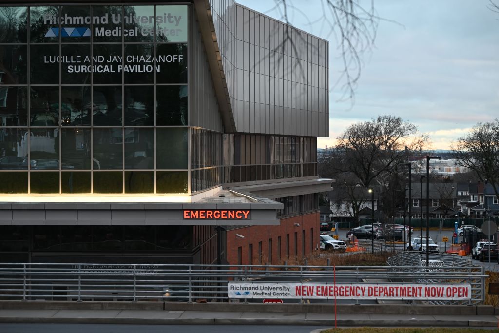 Several police vehicles are parked outside of Richmond University Medical Center after the Sunday morning attacks.