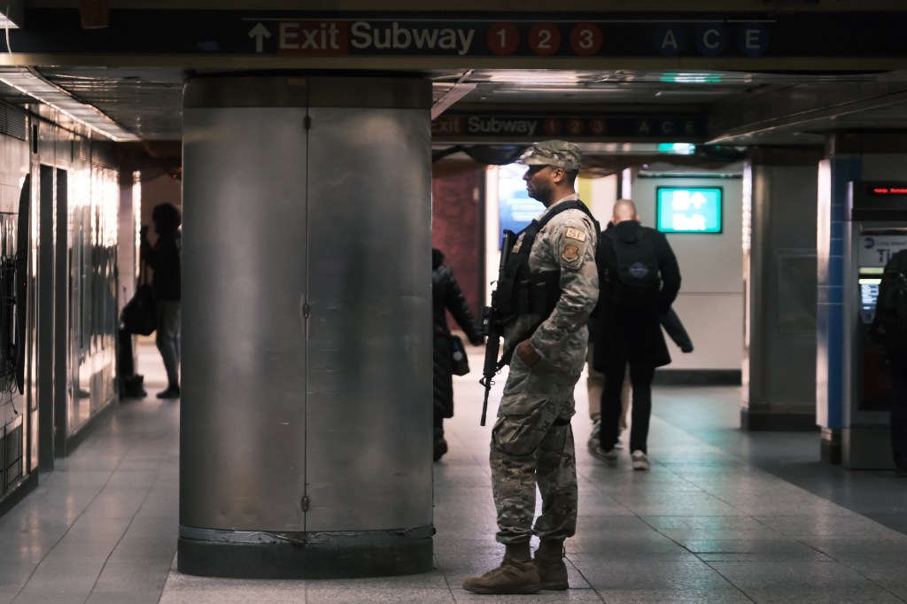 National Guard soldiers patrol Penn Station, New York, following deployment to perform bag checks in the crime-ridden subway system.