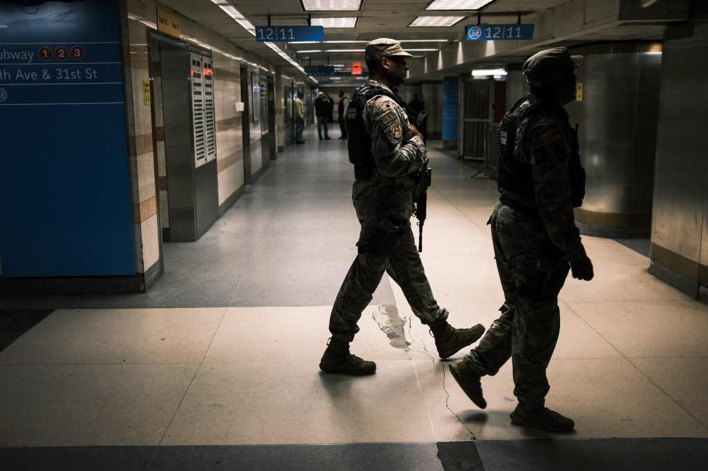 National Guard soldiers patrol Penn Station in New York, deploying to carry out subway bag checks.