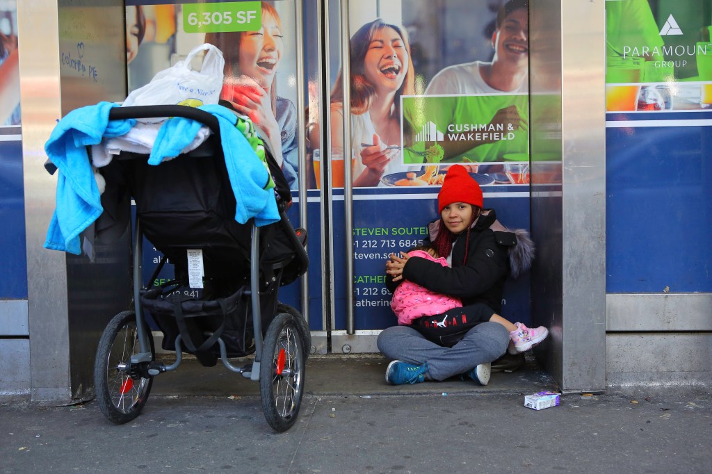 A stroller next to a sitting woman.