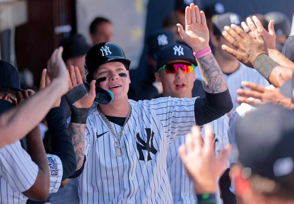 New York Yankees left fielder Alex Verdugo #24, gets high-fives in the dugout after scoring on Aaron Judgeâs single in the 1st inning.