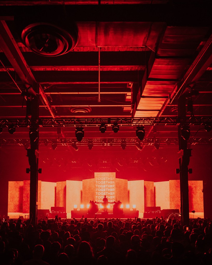 A stage with a crowd of people in the background.