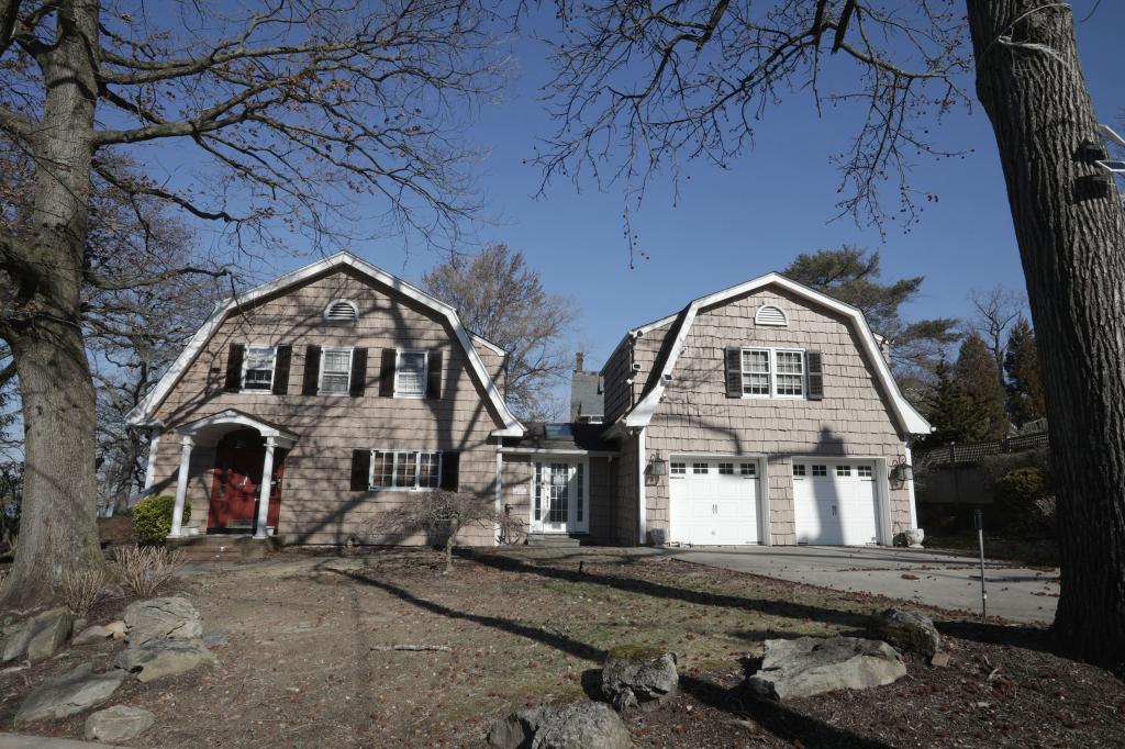 A house with a driveway and trees