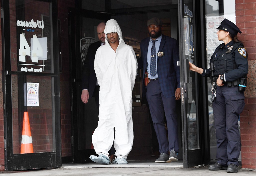 Sheldon Johnson getting walked out of the 44th Precinct stationhouse in the Bronx.