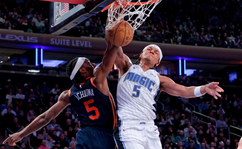 Paolo Banchero #5 of the Orlando Magic slams the ball over Precious Achiuwa #5 of the New York Knicks during the third quarter.