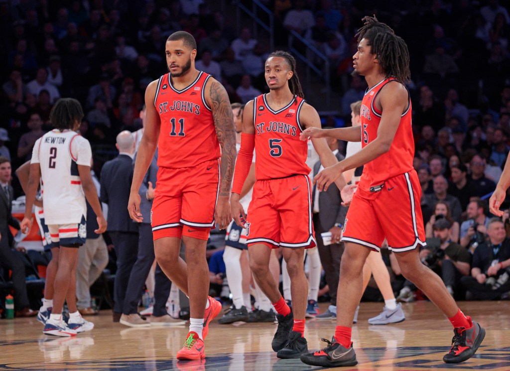 Red Storm center Joel Soriano #11 along with guard Daniss Jenkins #5 and forward Glenn Taylor Jr. #35 react on the floor during the second half.