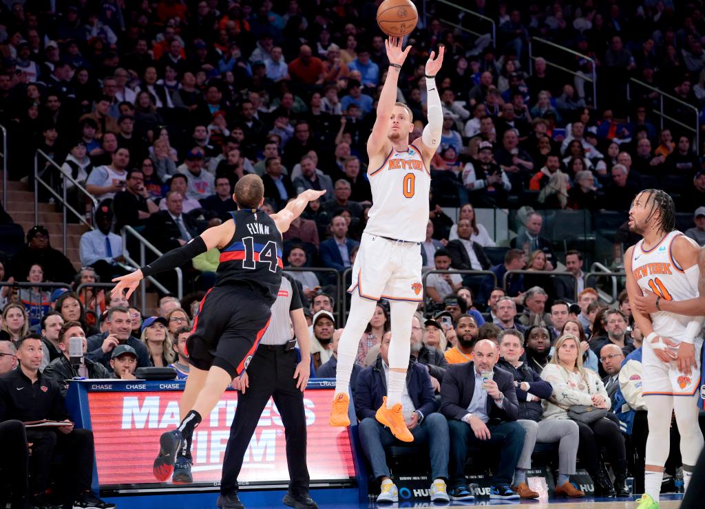 Donte DiVincenzo #0 of the New York Knicks puts up a shot over Malachi Flynn #14 of the Detroit Pistons during the third quarter.