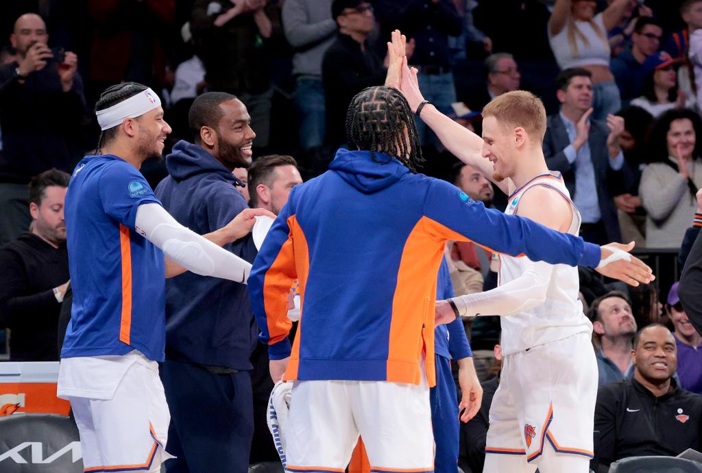 Donte DiVincenzo #0 of the New York Knicks is greeted by his teammates on the bench after DiVincenzo hits a three point shot during the fourth quarter. The New York Knicks defeated the Detroit Pistons 124-99