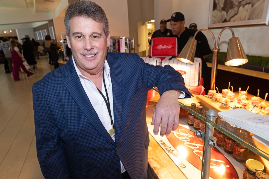 Lobel's co-owner Mark Lobel stands next to his new filet mignon tater tots.