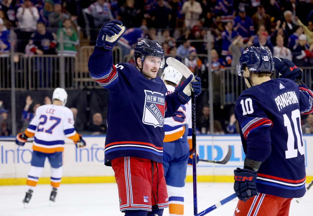 Alexis Lafreniere of the New York Rangers celebrates with Artemi Panarin on Sunday.