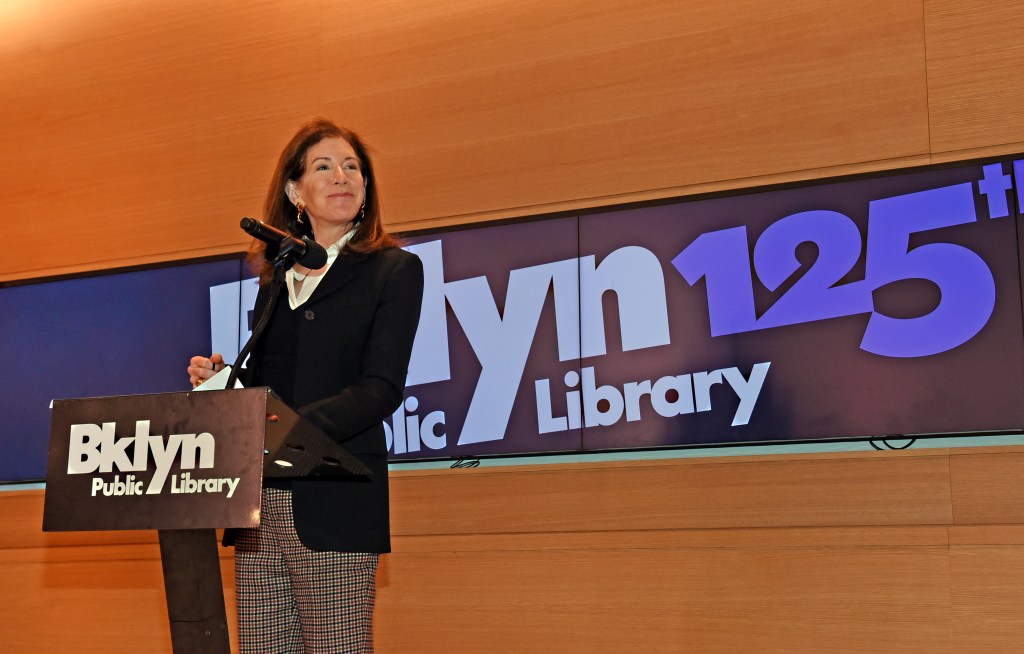 Brooklyn Public Library President Linda Johnson speaks at a podium at the brooklyn library 