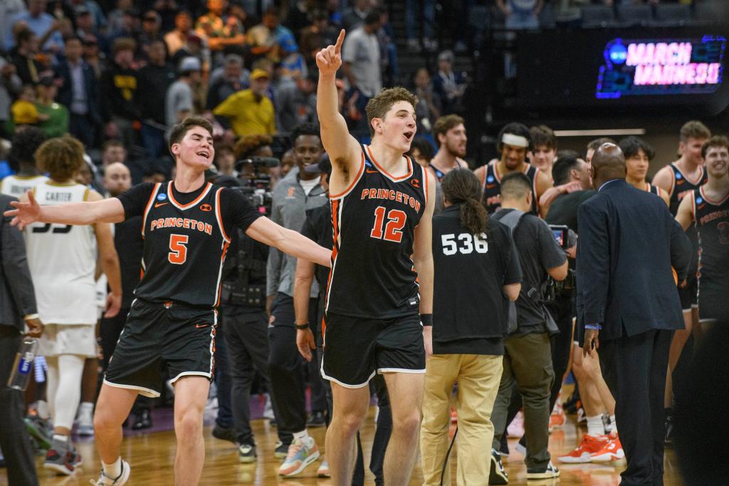 Princeton guard Jack Scott (3) and forward Caden Pierce (12) celebrate the team's win over Missouri