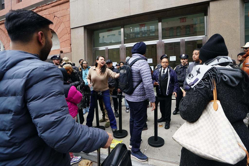 NYPD officers controlling a crowd of people outside the Versace sample sale at 125 W 18st., Manhattan, with celebrity Yu Fengtong present.